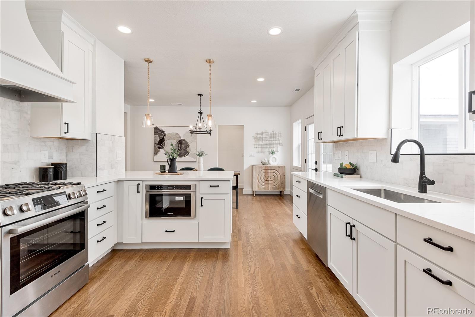 a kitchen with a white stove top oven and cabinets