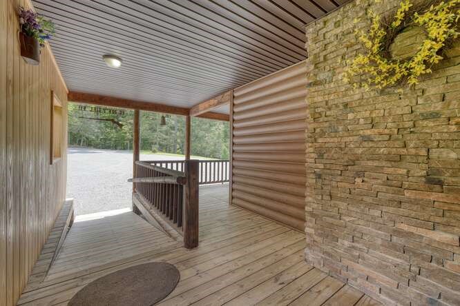 245 Panther Hill Road Murphy, NC 28906 - Photo 13 of 57 a view of a porch with wooden floor and floor to ceiling window
