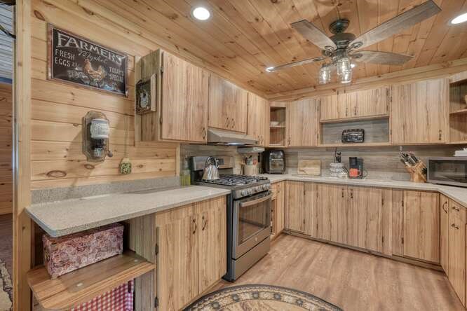 245 Panther Hill Road Murphy, NC 28906 - Photo 20 of 57 a kitchen with kitchen island granite countertop a sink cabinets stainless steel appliances and a counter space