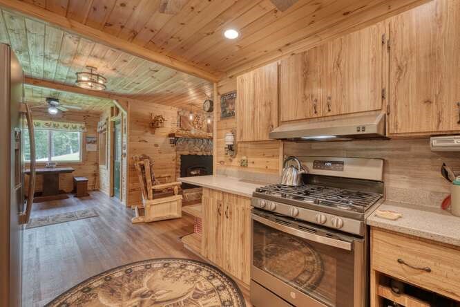 245 Panther Hill Road Murphy, NC 28906 - Photo 21 of 57 a kitchen with stainless steel appliances granite countertop a stove a sink dishwasher and a refrigerator with wooden floor