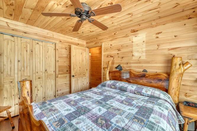 245 Panther Hill Road Murphy, NC 28906 - Photo 26 of 57 a bedroom with a bed and a chandelier