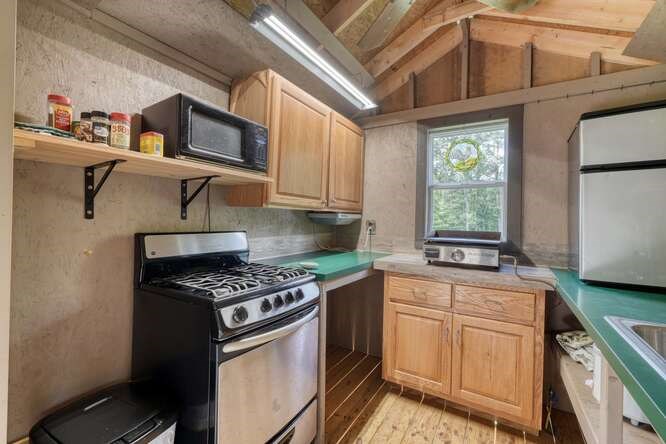 245 Panther Hill Road Murphy, NC 28906 - Photo 37 of 57 a kitchen with stainless steel appliances granite countertop a stove a sink and a microwave