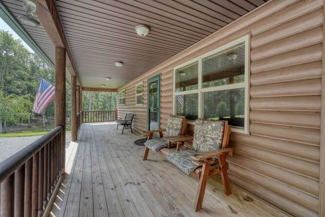 245 Panther Hill Road Murphy, NC 28906 - Photo 41 of 57 a balcony with chairs and wooden floor