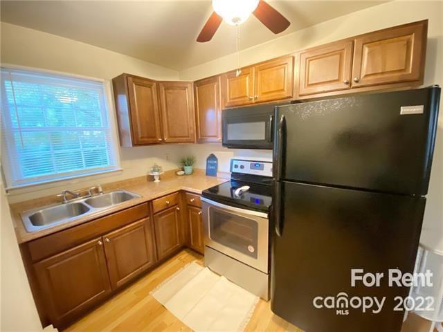 4226 Castleton Road Charlotte, NC 28211 - Photo 2 of 14 a kitchen with stainless steel appliances granite countertop a refrigerator a stove a sink and a stove