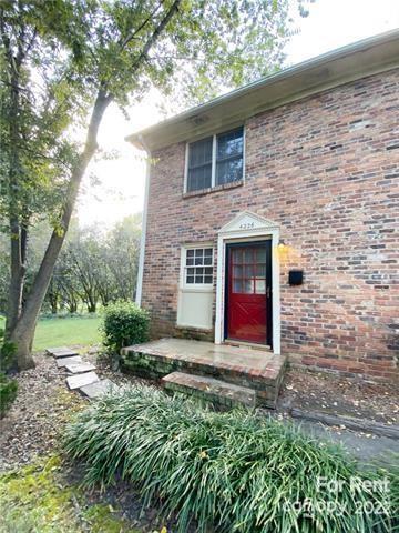 4226 Castleton Road Charlotte, NC 28211 - Photo 5 of 14 a view of a backyard with table and chairs and a large tree
