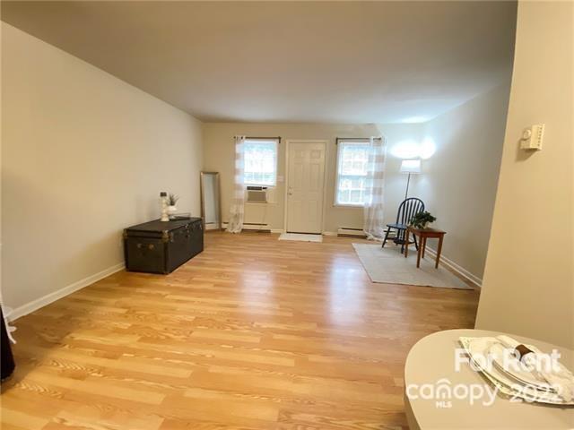 4226 Castleton Road Charlotte, NC 28211 - Photo 8 of 14 a view of a livingroom with wooden floor and a flat screen tv