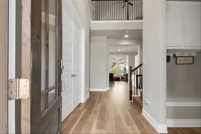 a view of a hallway with a dining table chairs and couches