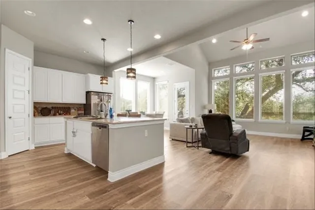 a kitchen with a refrigerator and a stove top oven