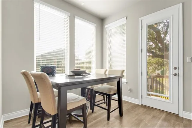 a view of a dining room with furniture and windows