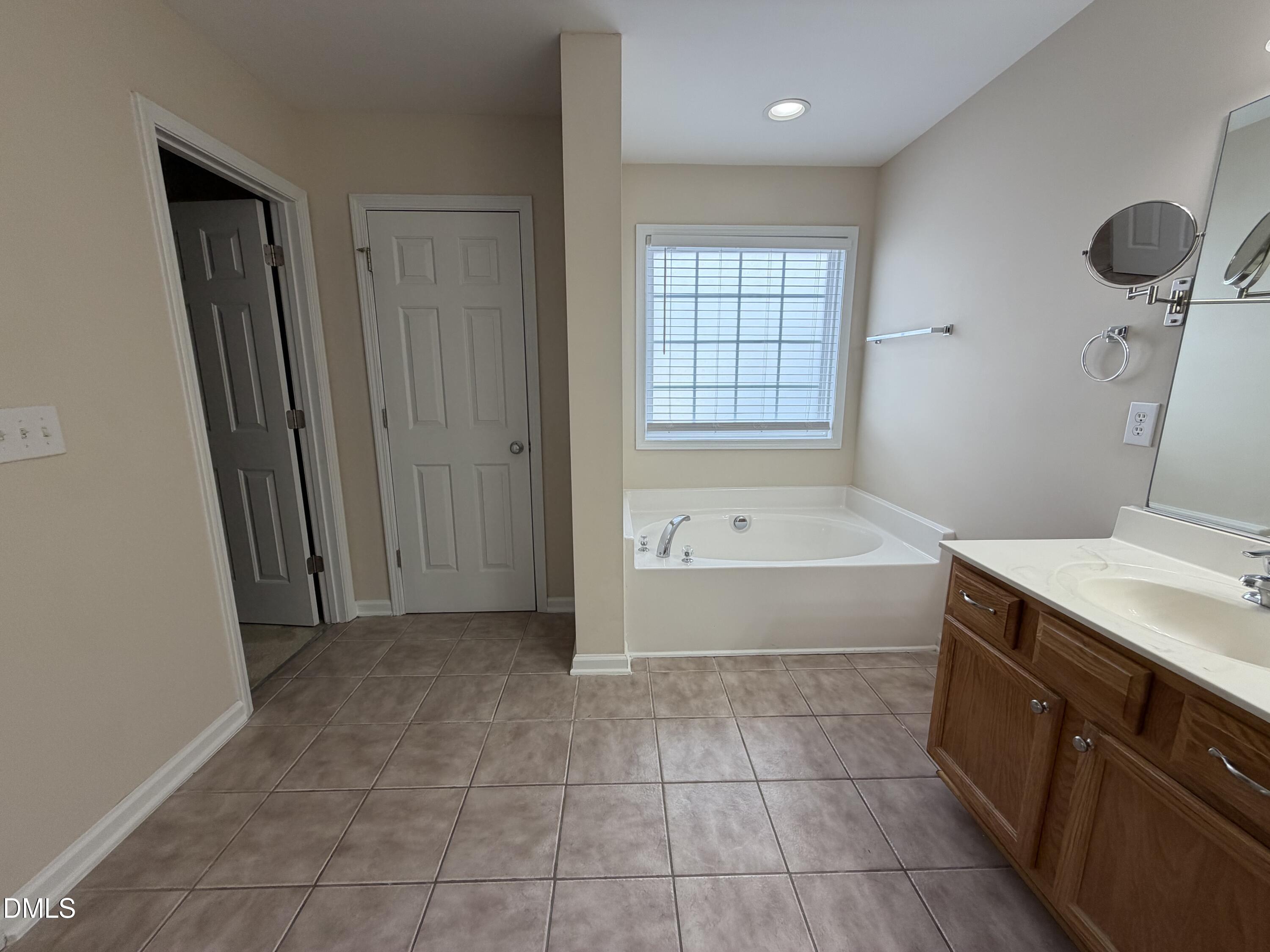 2418 Lazy River Drive Raleigh, NC 27610 - Photo 13 of 14 a bathroom with a bathtub and a sink