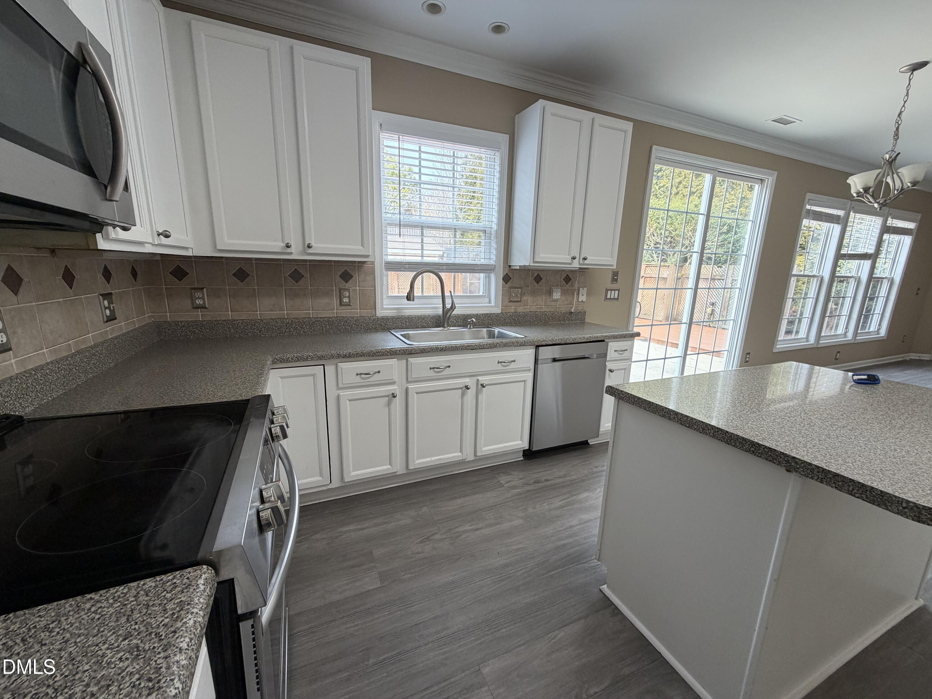 2418 Lazy River Drive Raleigh, NC 27610 - Photo 3 of 14 a kitchen with a sink stove and cabinets
