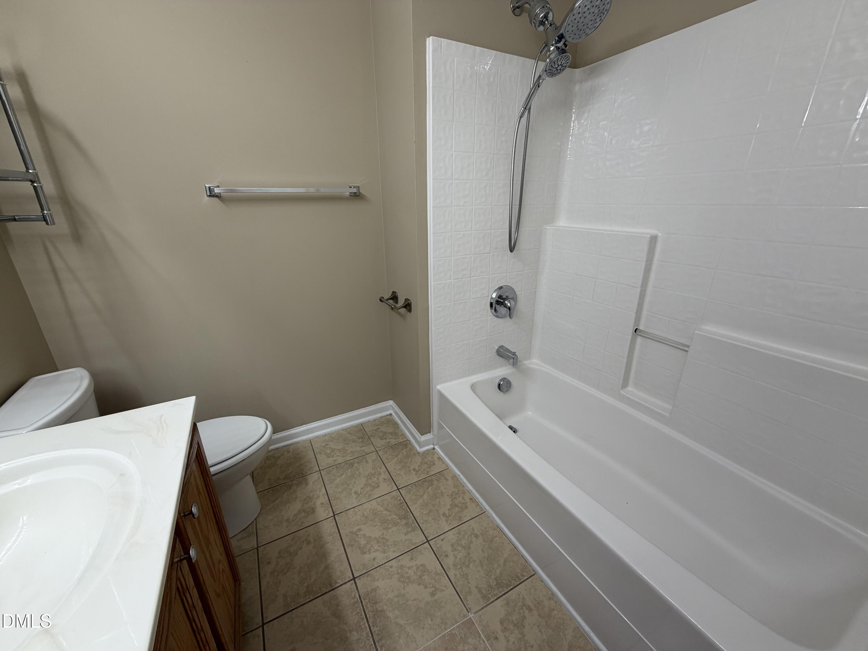 2418 Lazy River Drive Raleigh, NC 27610 - Photo 10 of 14 a bathroom with a bathtub and a shower