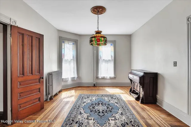 a view of a dining room with furniture window and wooden floor