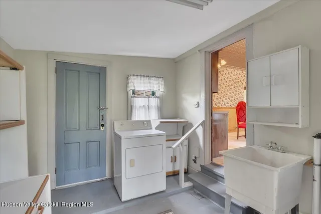 an empty room with a window and wooden floor