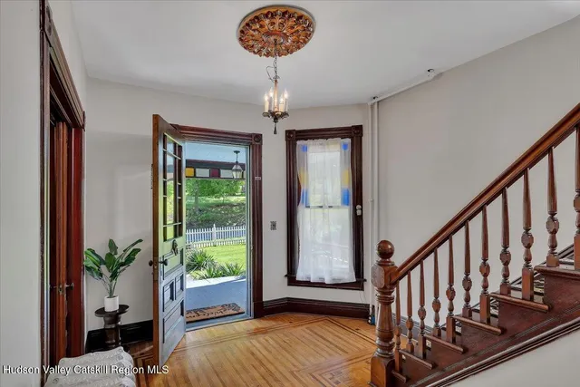 a view of entryway with a potted plant and wooden floor