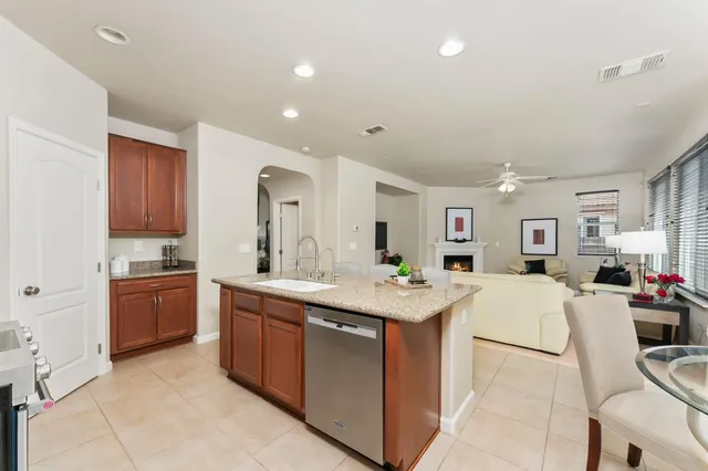 a living room with furniture flower pot and a fireplace