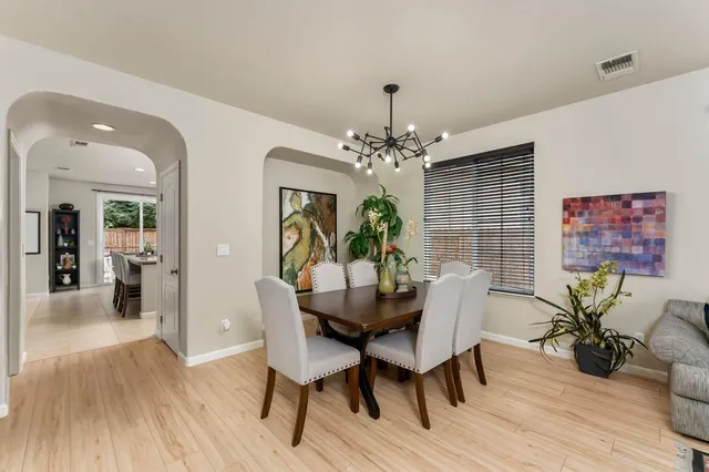 a dining hall with stainless steel appliances granite countertop a sink and a refrigerator
