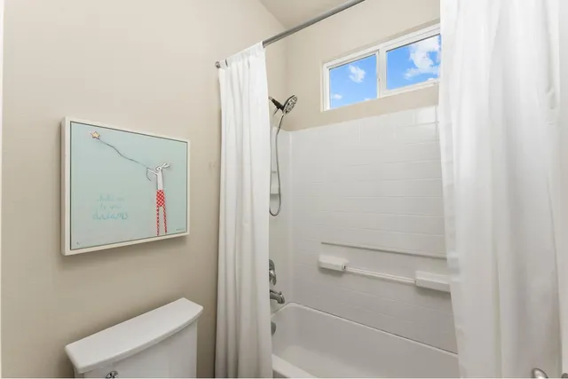 a bedroom with two beds and a window