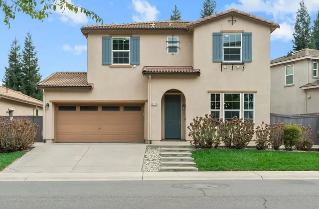 a kitchen with a sink a kitchen island and stainless steel appliances