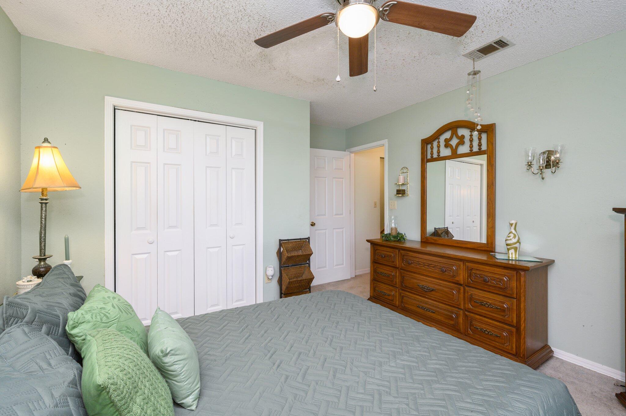 811 Valley Road Crestview, FL 32539 - Photo 19 of 26 a bedroom with a bed and a chandelier