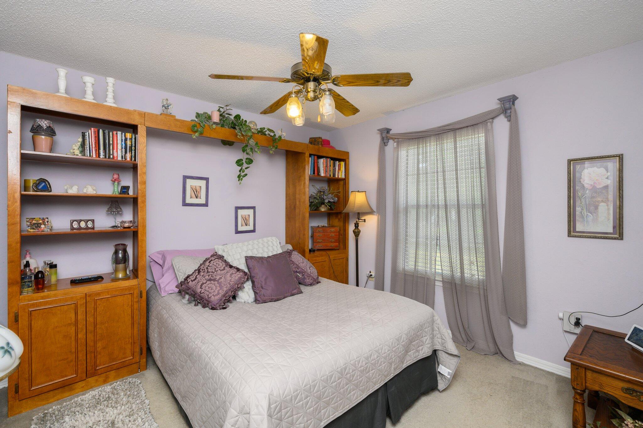 811 Valley Road Crestview, FL 32539 - Photo 20 of 26 a bedroom with a bed and cabinets