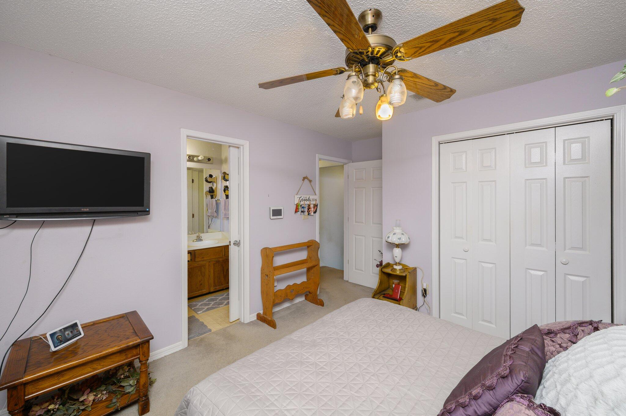 811 Valley Road Crestview, FL 32539 - Photo 21 of 26 a bedroom with a bed and a flat tv screen on dresser