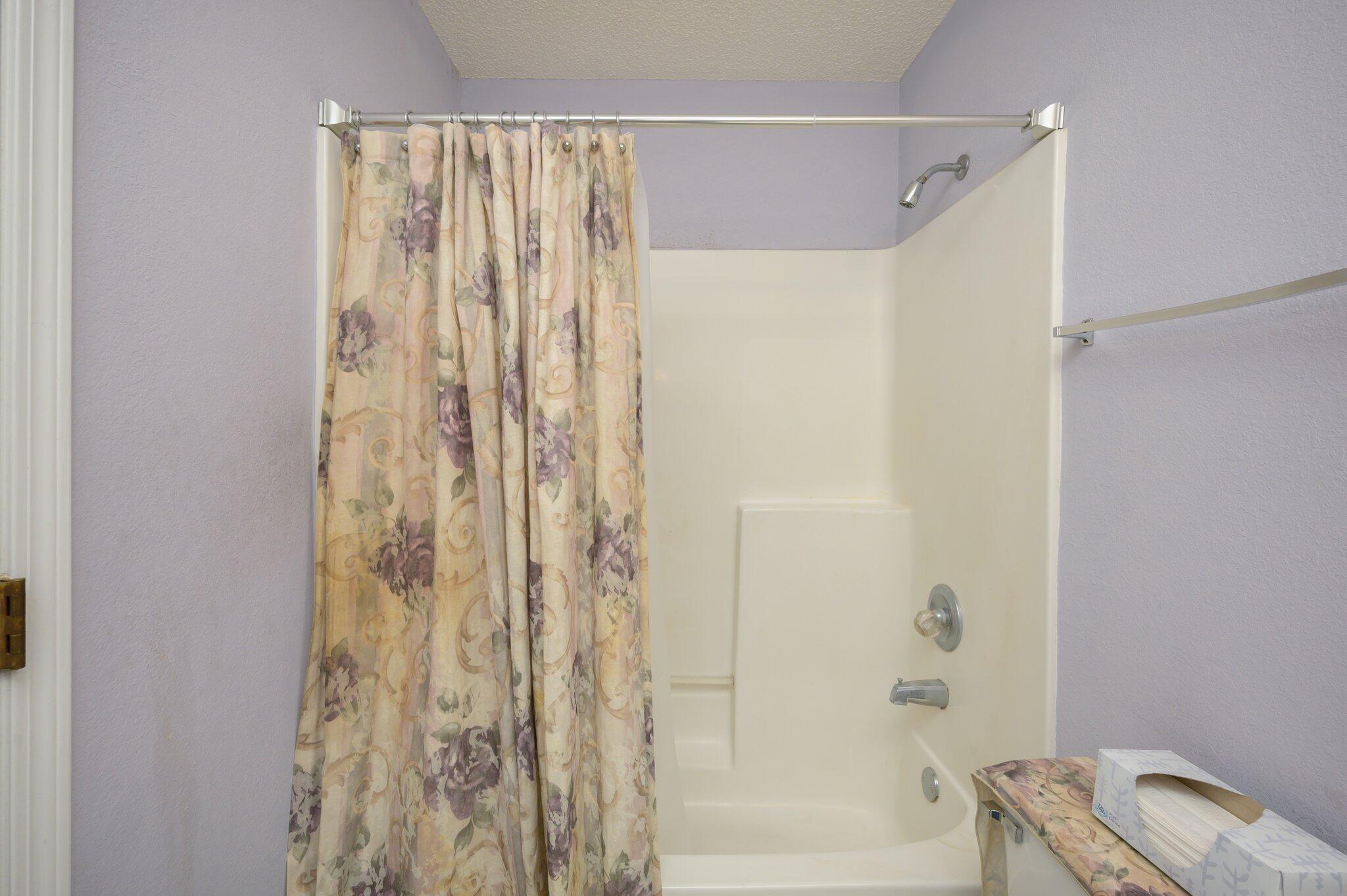 811 Valley Road Crestview, FL 32539 - Photo 23 of 26 a bathroom with a shower curtain and a window