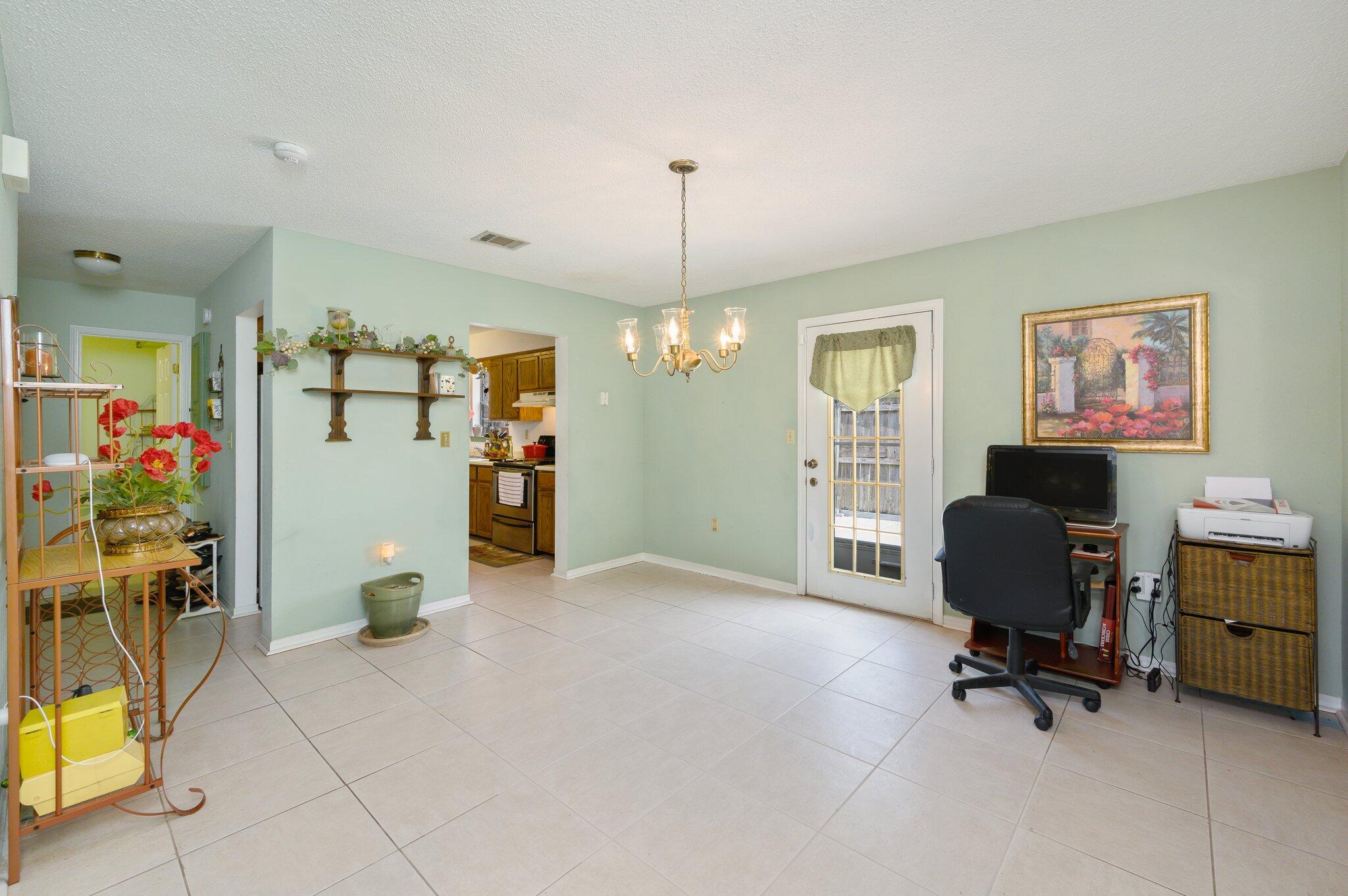 811 Valley Road Crestview, FL 32539 - Photo 8 of 26 a view of a workspace with furniture and a window