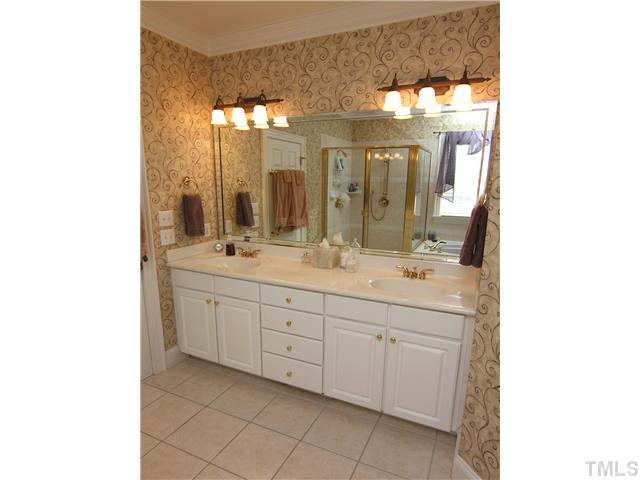 12501 Ribbongrass Court Raleigh, NC 27614 - Photo 15 of 25 Master bath features dual vanities with tile floor. Glass enclosed shower and garden tub Master Bath/Spa