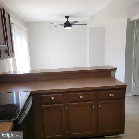 a kitchen with a refrigerator a stove a sink and a window