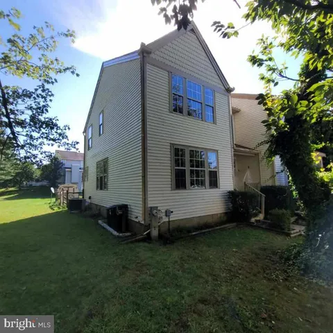 a view of house with backyard