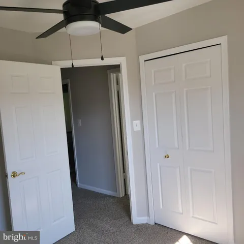 a white toilet sitting next to a bath tub