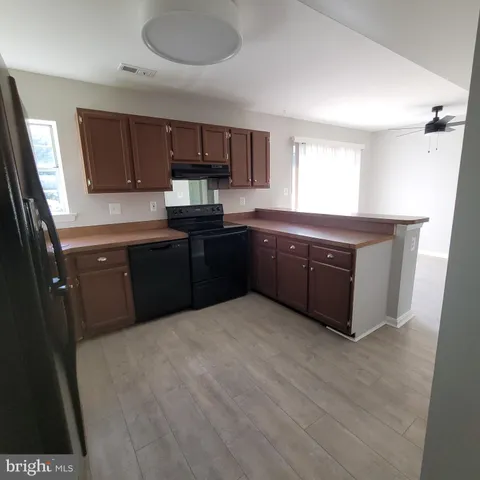 a kitchen with granite countertop a cabinets and steel stainless steel appliances