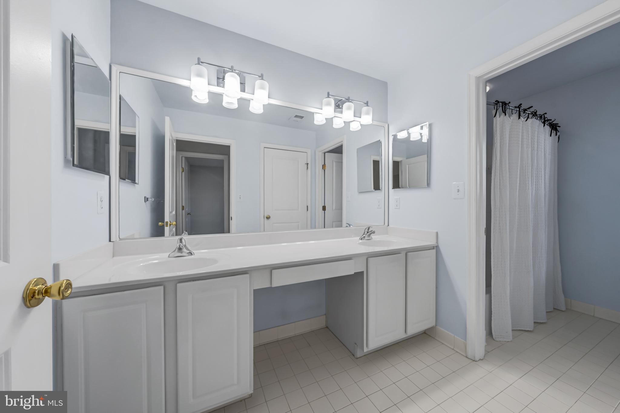 9231 Ribbon Falls Loop Bristow, VA 20136 - Photo 30 of 40 a bathroom with a double vanity sink and a mirror