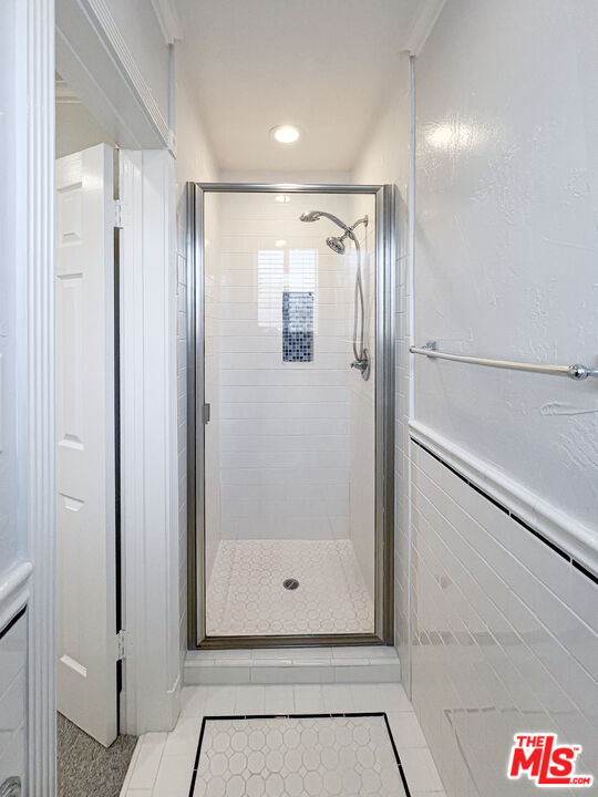 930 South Bedford Street, Unit 4 Los Angeles, CA 90035 - Photo 15 of 24 a bathroom with a shower and a glass door