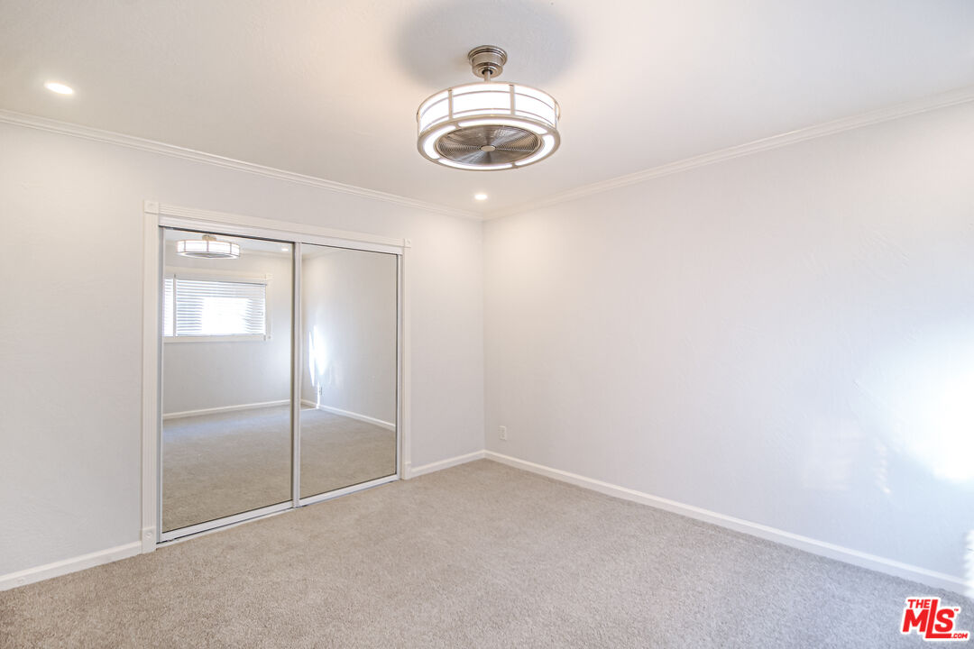 930 South Bedford Street, Unit 4 Los Angeles, CA 90035 - Photo 19 of 24 an empty room with cabinet and chandelier