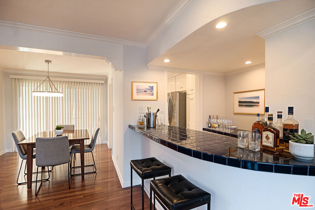 930 South Bedford Street, Unit 4 Los Angeles, CA 90035 - Photo 2 of 24 a view of a dining room with furniture and wooden floor