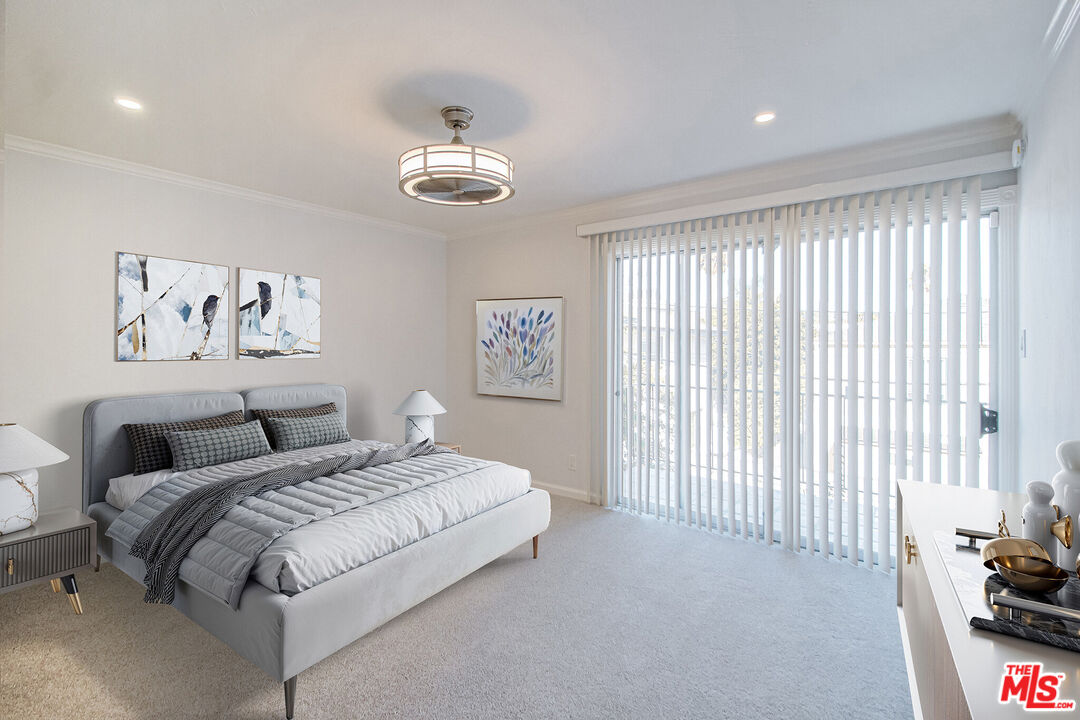 930 South Bedford Street, Unit 4 Los Angeles, CA 90035 - Photo 9 of 24 a bedroom with a bed and a chandelier