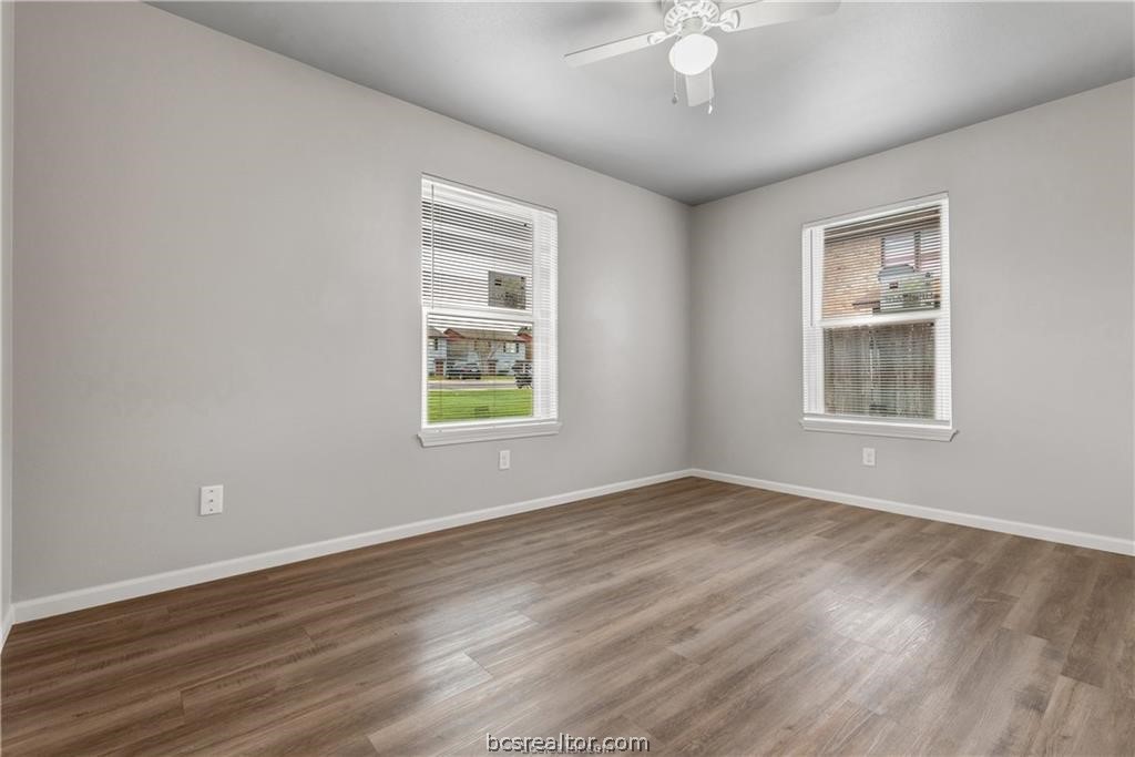 804 Navidad Street, Unit A Bryan, TX 77801 - Photo 9 of 11 a view of an empty room with wooden floor and a window