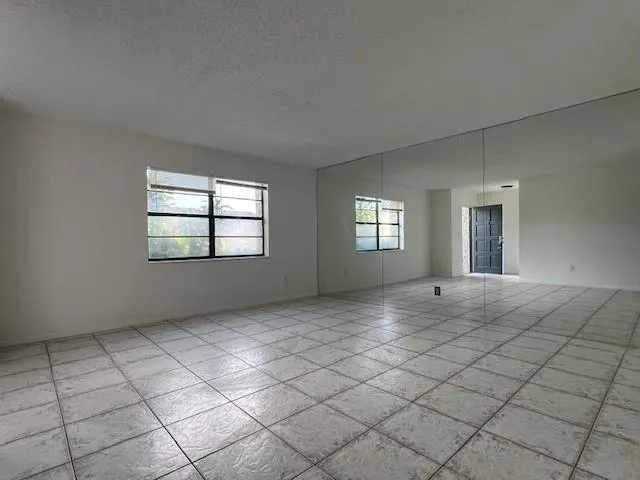 a view of an empty room with windows