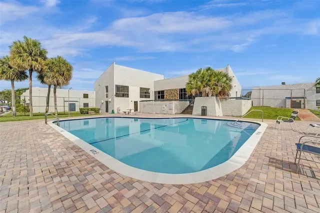a view of a swimming pool with a patio