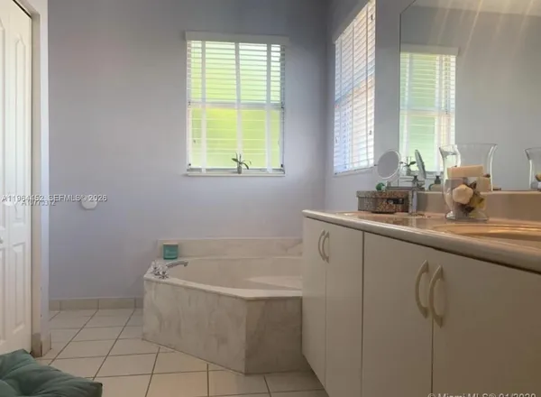 a bathroom with a tub sink and window