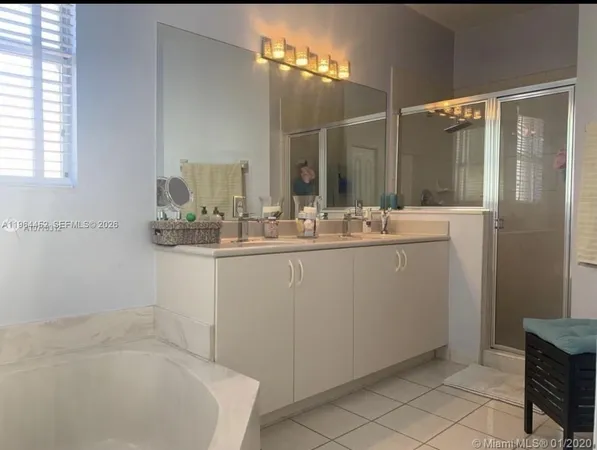 a bathroom with a sink a mirror and a shower