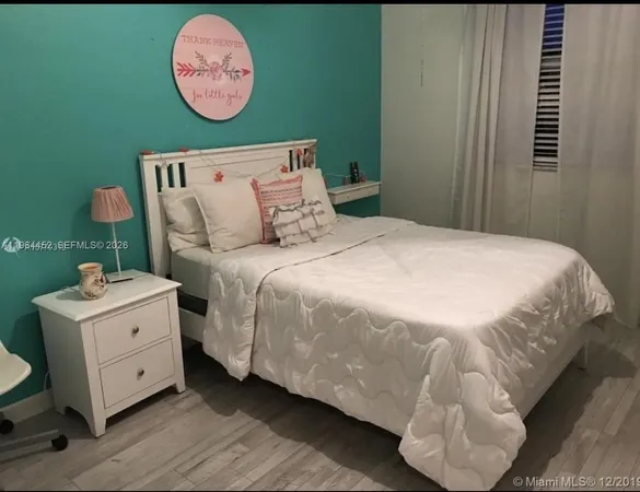 a bedroom with a bed and a table in it