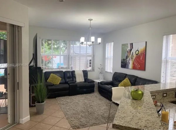 a living room with furniture and a chandelier