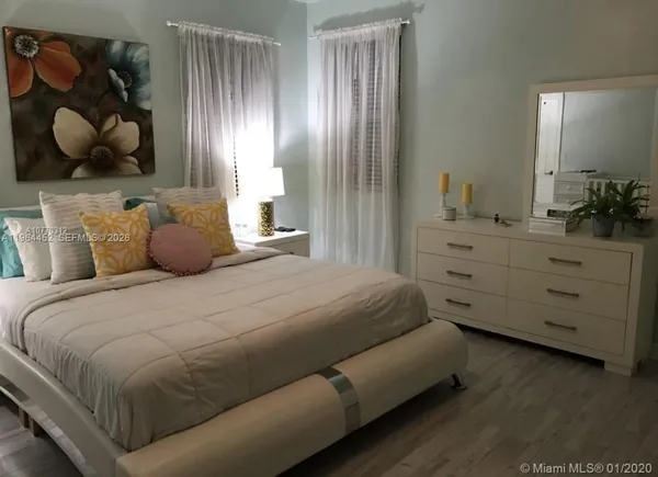 a bedroom with a bed and cabinets