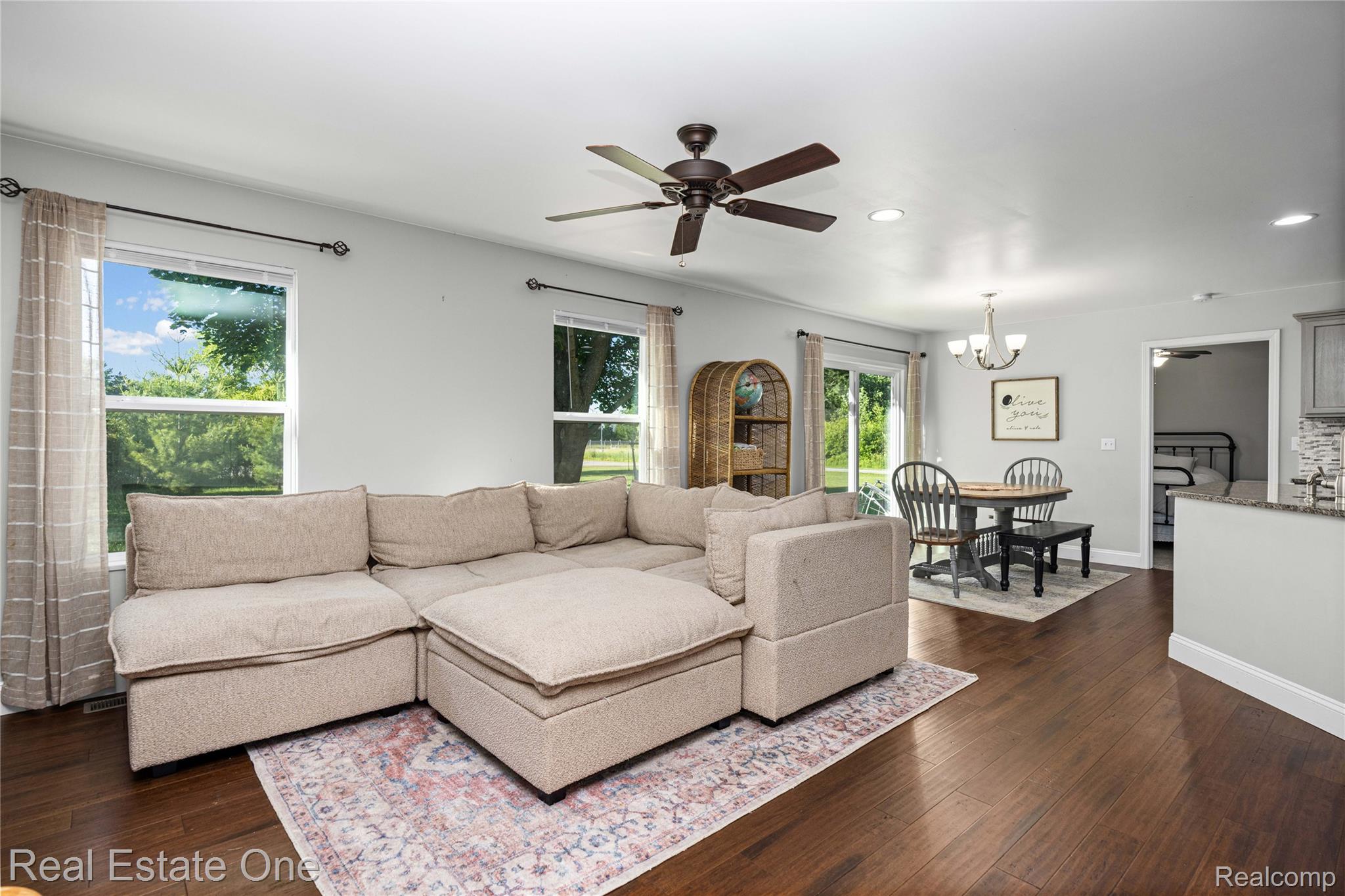 2479 Gibson Road Grand Blanc, MI 48439 - Photo 13 of 55 Open-concept living area featuring rich wood-finish flooring, recessed lighting, and a ceiling fan