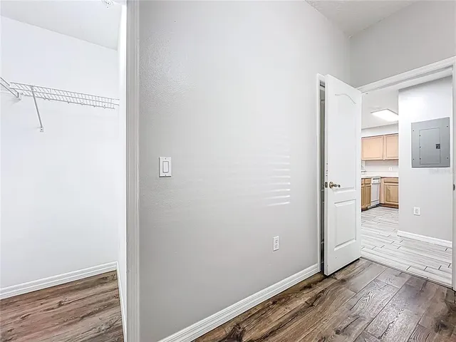 a view of a room with wooden floor