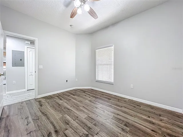 wooden floor in an empty room with a window