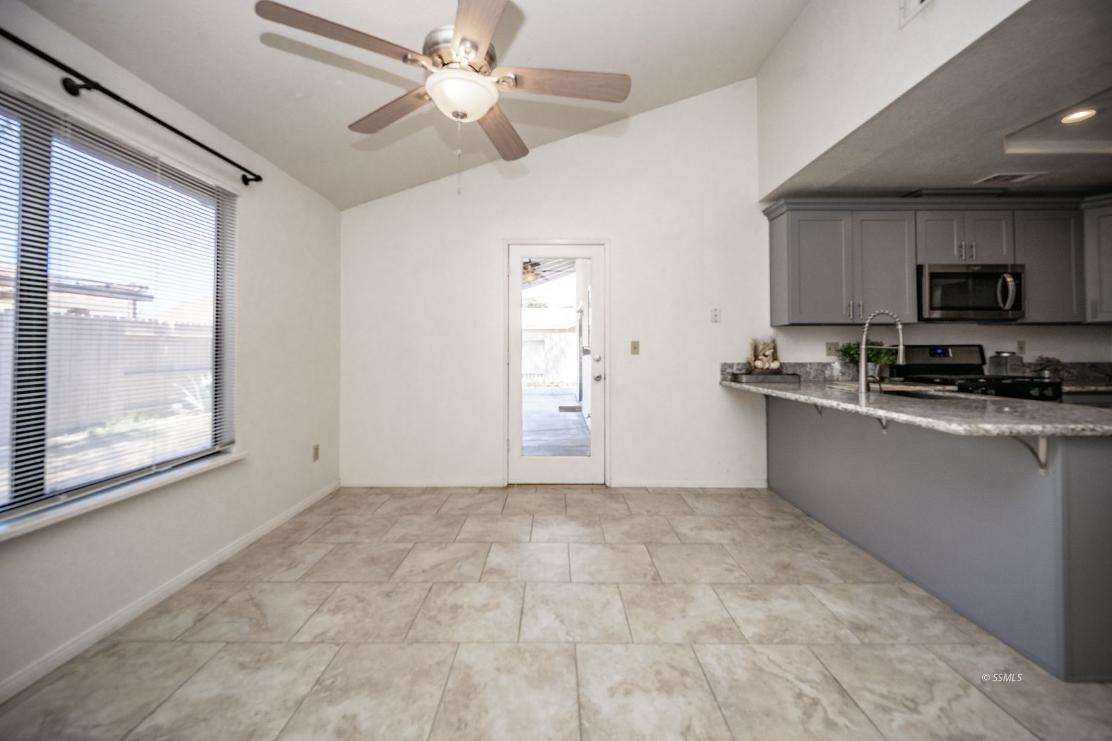 704 Beth Lane Ridgecrest, CA 93555 - Photo 19 of 39 a view of a kitchen with microwave and a stove top oven
